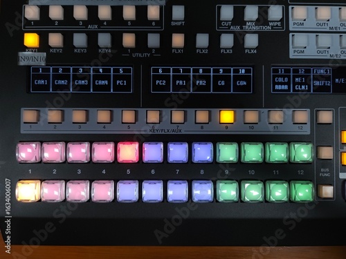 Fotografie Close-up of a professional video switcher panel with illuminated buttons in a broadcast control room