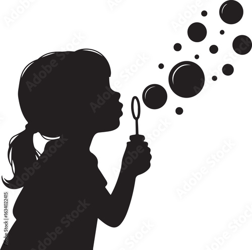 Silhouette of a young girl blowing bubbles