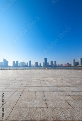 Empty square floor with panoramic Shenzhen skyline, modern architecture under blue sky - high-resolution symmetrical urban photography