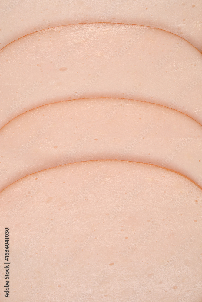 Fototapeta premium A close-up shot of several pink slices of chicken breast cold cuts, photographed from the top