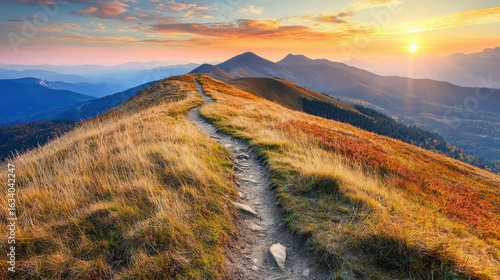 Fototapeta Naklejka Na Ścianę i Meble -  Mountain trail leading along the mountain ridge of beautiful mountains with autumn grass and colorful sky. 