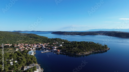 Božava (Bozava) blends serene charm and vivid colors—quaint stone houses, turquoise sea, and sunlit boats create a dreamy Adriatic scene, ideal for captivating, story-rich photography.