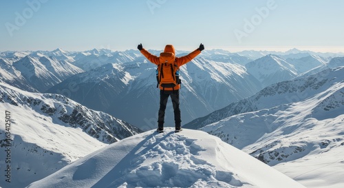 Hiker celebrates reaching the summit of a snowcovered mountain with open arms