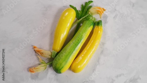 Top view of colorful zucchini on light textured background. Perfect for healthy eating and vegan dishes. Close-up, top view. Organic zucchini, yellow zucchini, green zucchini