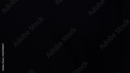 Man showing an old key against the palm of his hand