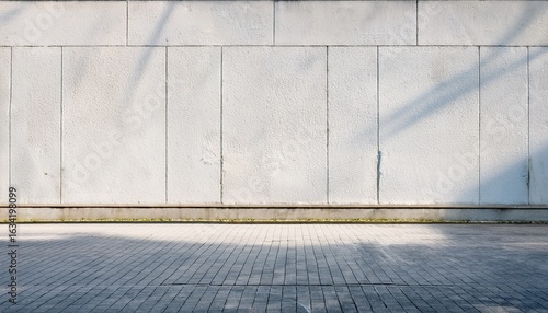 city street with long concrete wall covered in white plaster featuring copy space and mockup