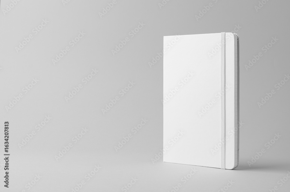 Fototapeta premium White hardcover notebook mockup on neutral background