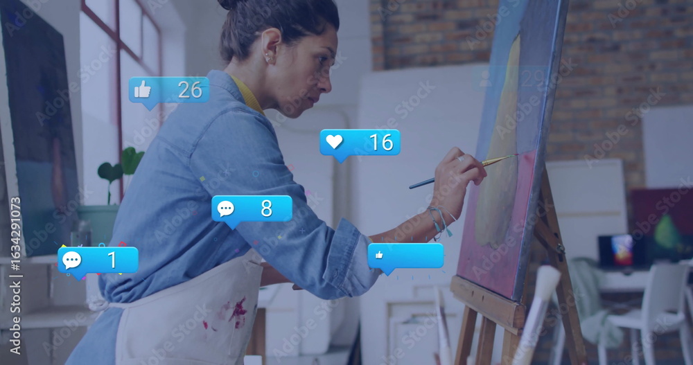 Obraz premium Painting artist wearing apron painting abstract circle on canvas in studio, with alerts, copy space