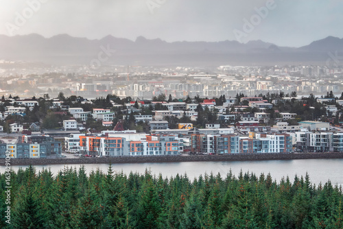 A panoramic view of Kópavogur, a residential area, south of Reykjavík in Iceland with distant mountains shrouded in haze