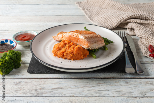 Delicious Salmon Served With Vibrant Carrot Puree