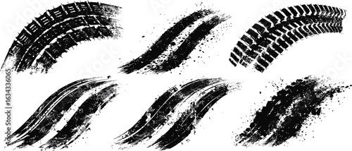 A collection of black grunge tire tracks and abstract dirty brush strokes. Automotive tread print concept for creative design elements.