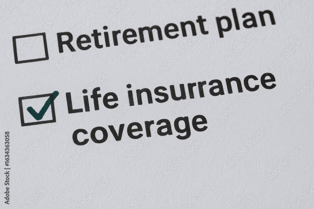 Fototapeta premium Life insurance coverage checked with retirement plan option on paper representing financial security with life insurance for retirement planning