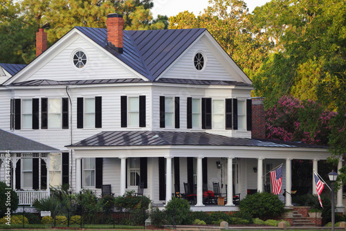 Tableau sur toile Black and white historic patriotic home flying American flag on Edenton Bay, Edenton, NC