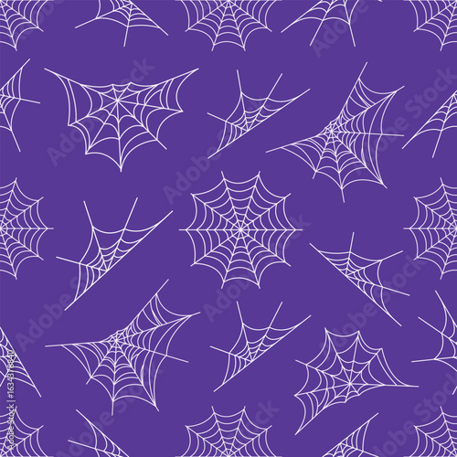 A seamless vector pattern of white spider webs of various shapes on a deep purple background. Perfect for Halloween, spooky themes, decorations, and textile designs.