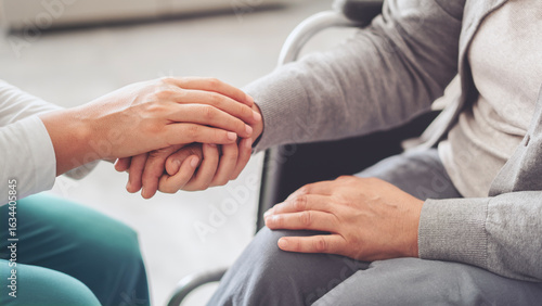 Young carer giving helping hands for the elderly woman