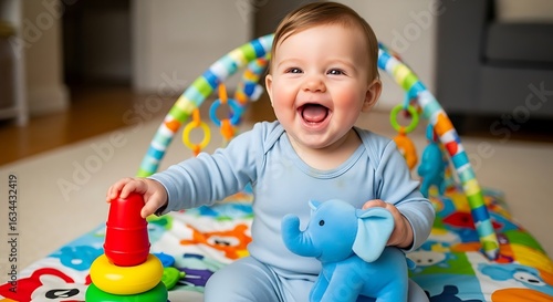 Happy baby boy laughing and playing with colorful toys on a play mat at home
