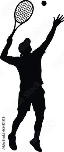 Silhouette of a tennis player serving the ball during a competitive match on the court with a racket