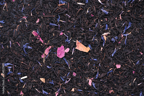 Top view photography of dried Black Tea with roses petals and blue cornflower petals