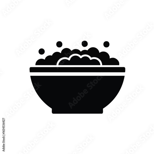 Black silhouette icon of a bowl with soap suds. Minimalist vector graphic for cleaning, washing, or hygiene concepts.
