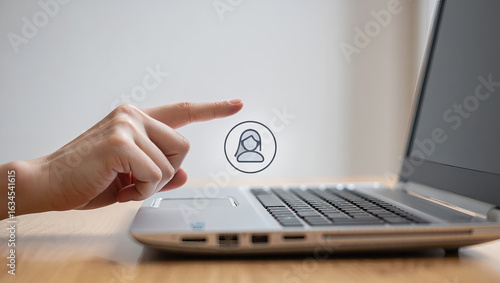 Connecting Digitally A Person's Finger Hovering Over a User Profile Icon on a Laptop Representing Online Identity and Social Networking in a Modern Context