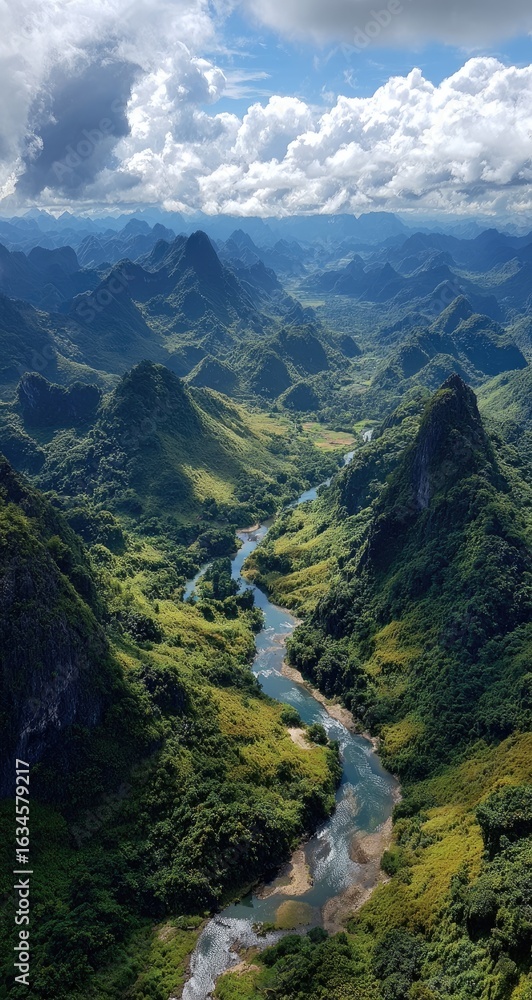 Obraz premium Lush valley winding through jagged peaks
