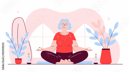 An elderly woman with grey hair meditates in the lotus position on a yoga mat, surrounded by plants and candles.