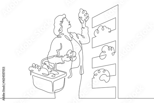 Continuous one line drawing woman chooses food products in a store.One continuous line isolated minimal illustration.Not AI.
