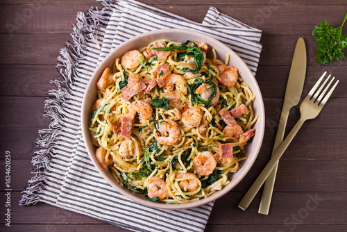 Seafood pasta with spinach and bacon. Spaghetti with shrimps. High angle view