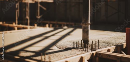 Foto Construction site with concrete slab forms and metal supports under bright sunlight, showcasing structural foundation work in the early phase of a building project