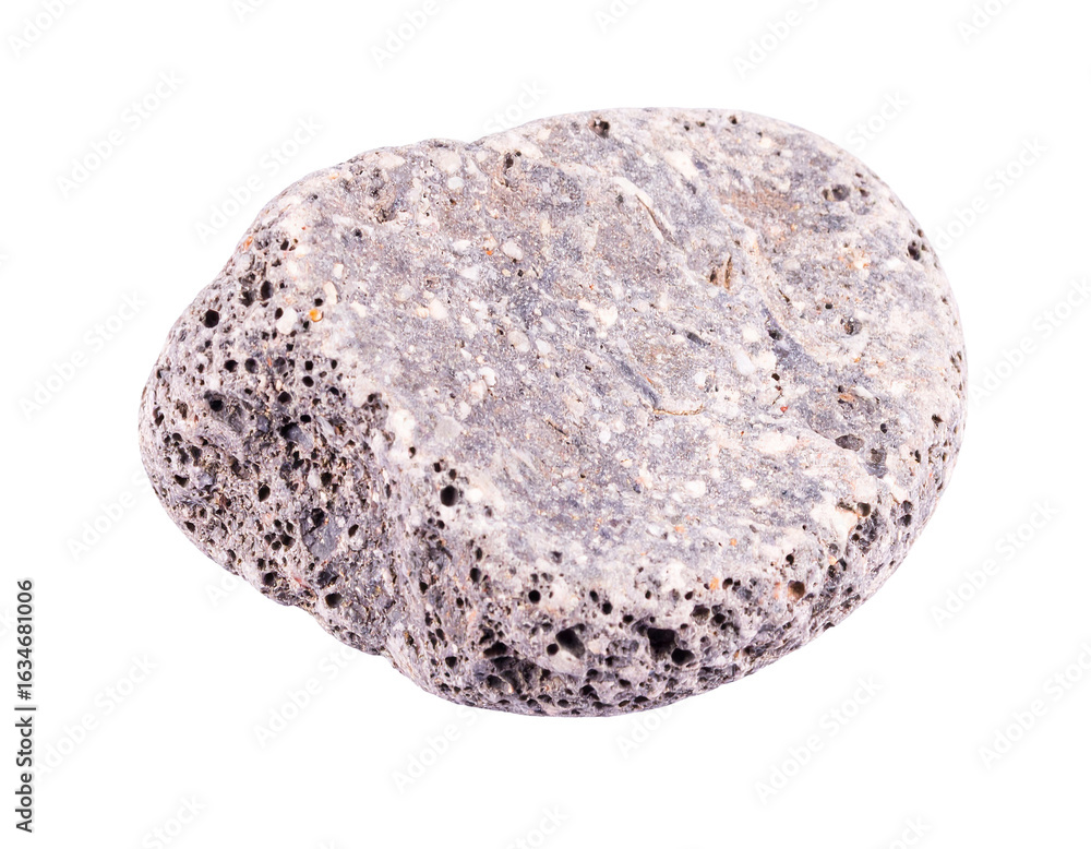 Obraz premium A pumice stone with a rough, porous surface and a gray-brown color, a classic example of lightweight volcanic rock, isolated on a white background.