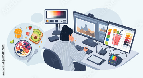 Freelance Graphic Designer working at home with healthy breakfast and multiple monitors