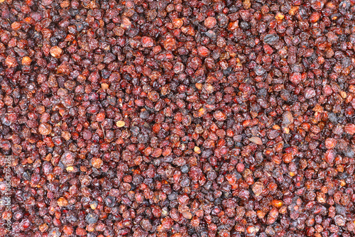 Fotografie Detailed macro shot of dried barberries, small red fruits with a wrinkled surface and vibrant color