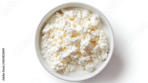 Top-down view of a white bowl filled with creamy cottage cheese or rice pudding, textured curd surfaces against a clean white background.