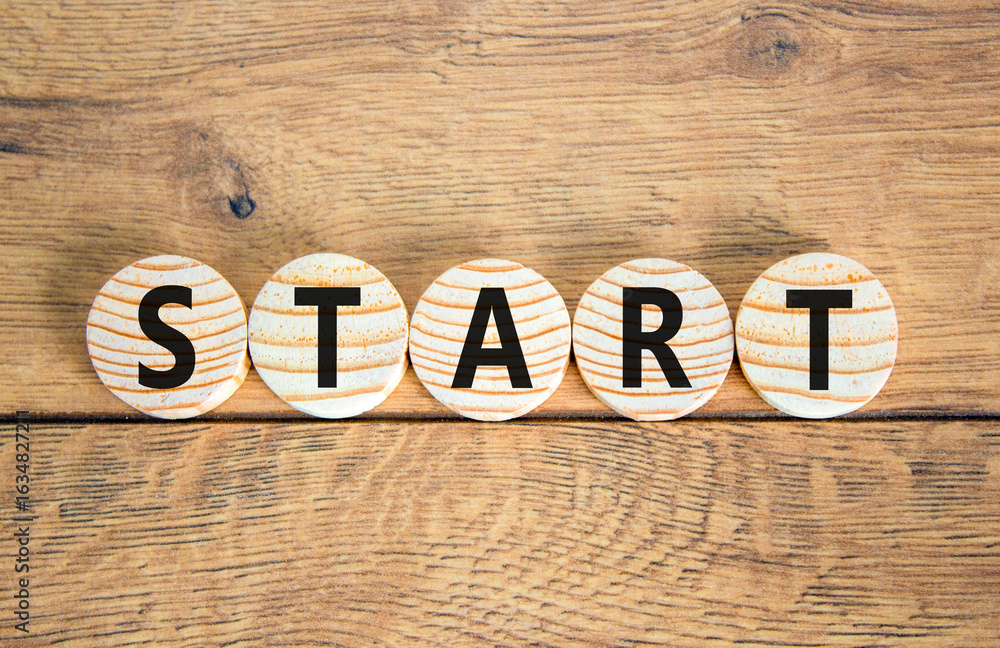 Fototapeta premium Start symbol. Concept word Start on beautiful wooden circles. Beautiful wooden table wooden background. Business lifestyle start concept. Copy space.