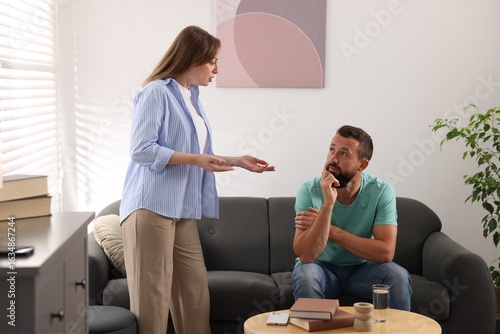 Konstfotografi Betrayal. Emotional woman talking to her husband at home