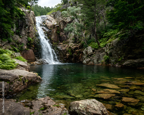 Majestic waterfall cascading into a tranquil pool