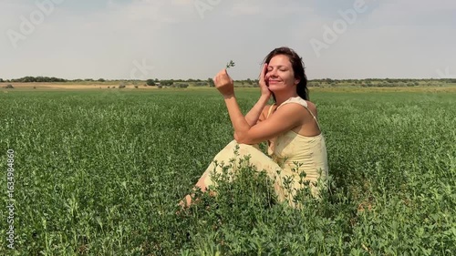 Happy girl sitting in a field