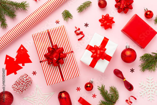 Handmade wrapped christmas gift boxes with stuff on color background, top view