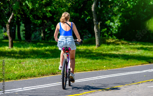 Wallpaper Mural Cyclist ride on the bike path in the city Park
 Torontodigital.ca