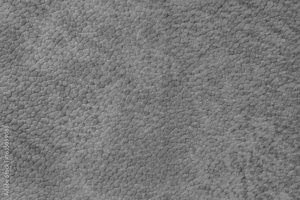 Fototapeta premium Detailed close up, macro of gray synthetic suede leather texture, faux leather, leatherette. Background for design, fashion, upholstery material visuals. Natural grain structure, soft look.