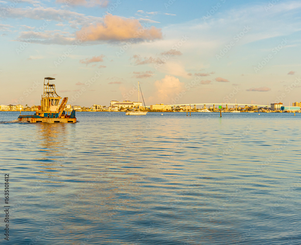 Fototapeta premium Small Tugboat and Sailboats on San Carlos Bay, Bowditch Point Park, Fort Myers Beach, Florida, USA