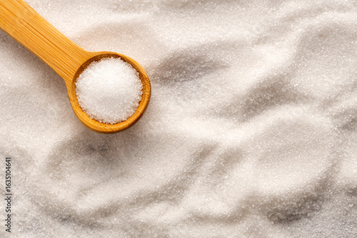Photos Saccharum officinarum - Fine crystals of refined white sugar on a wooden spoon