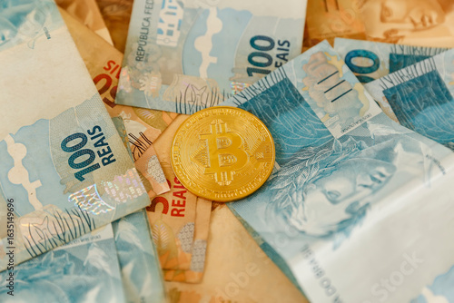 Golden Bitcoin coin with scattered one hundred and fifty real bills