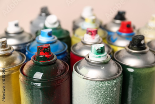 Many spray paint cans on be...