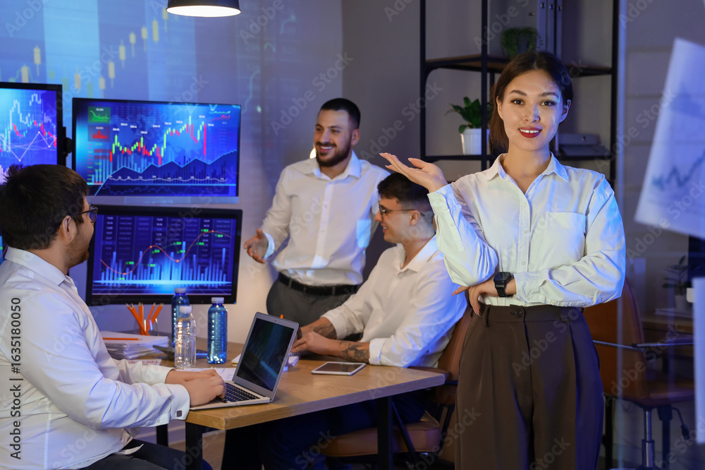 Fototapeta premium Portrait of female Asian trader in office at night