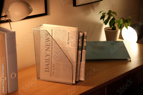 Holder with newspapers on d...