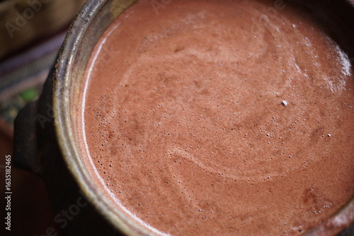 Traditional Guatemalan Mayan chocolate making with cacao beans, comal plate and metate