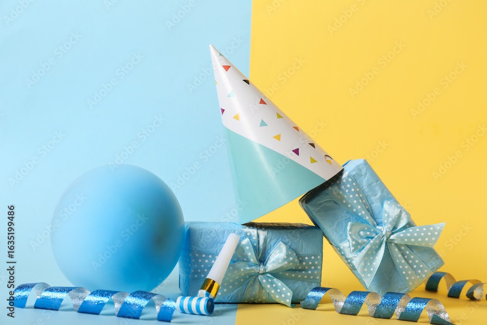 Fototapeta premium Composition with beautiful gift boxes, party hat and balloon on color background