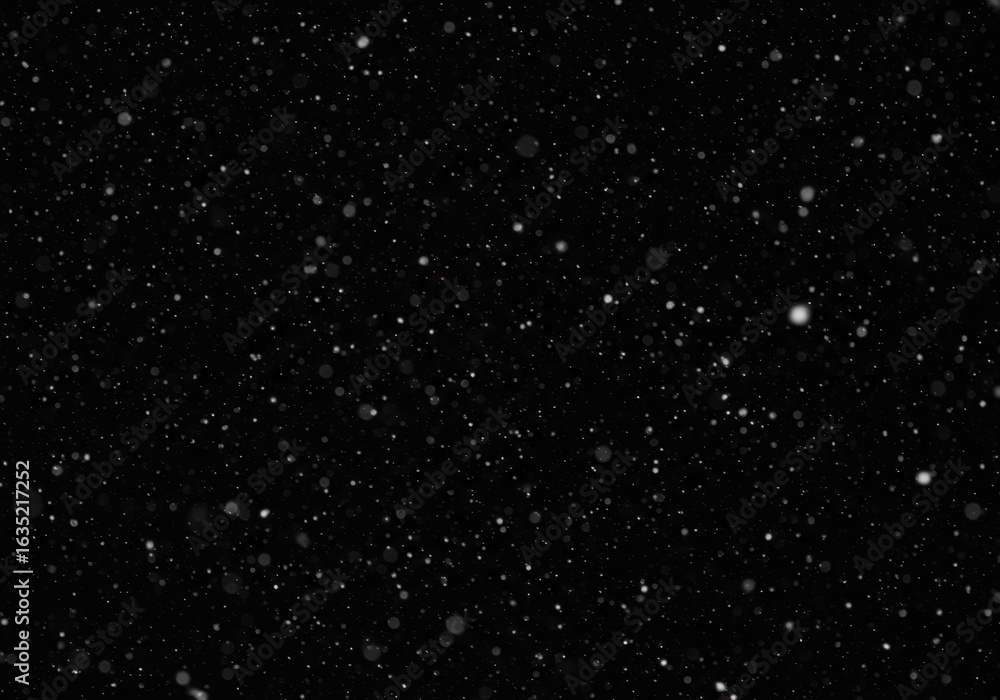 Fototapeta premium Falling snow particles on a dark black background, winter atmosphere