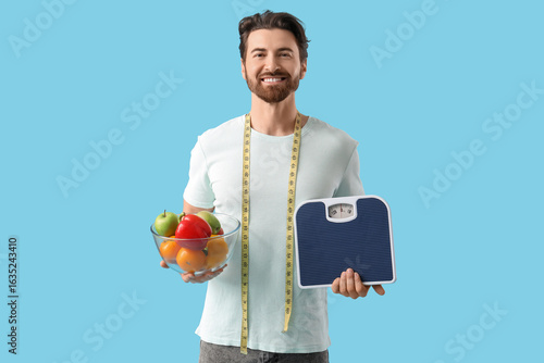 Young man with weight scale...